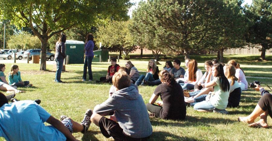 International Club members gather at the annual opening picnic to discuss plans for this year at Centennial Park.