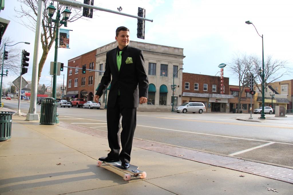 Senior Brandon Schwarz long boards in his prom tuxedo from BJs Fashions For Men. Photo taken by Kyle Heywood