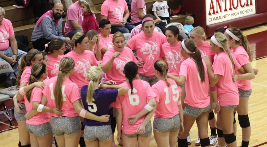 Coach Jamie Atkinson going over plays with the Varsity Volleyball Team.