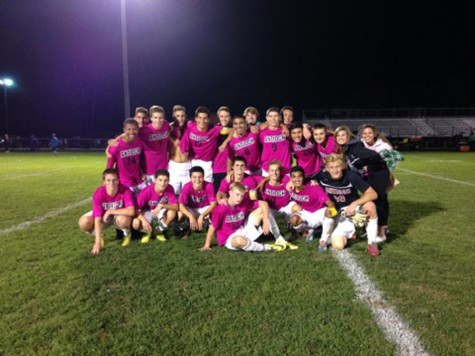 The boys Varsity soccer team wearing pink jerseys for Breast Cancer Awareness.