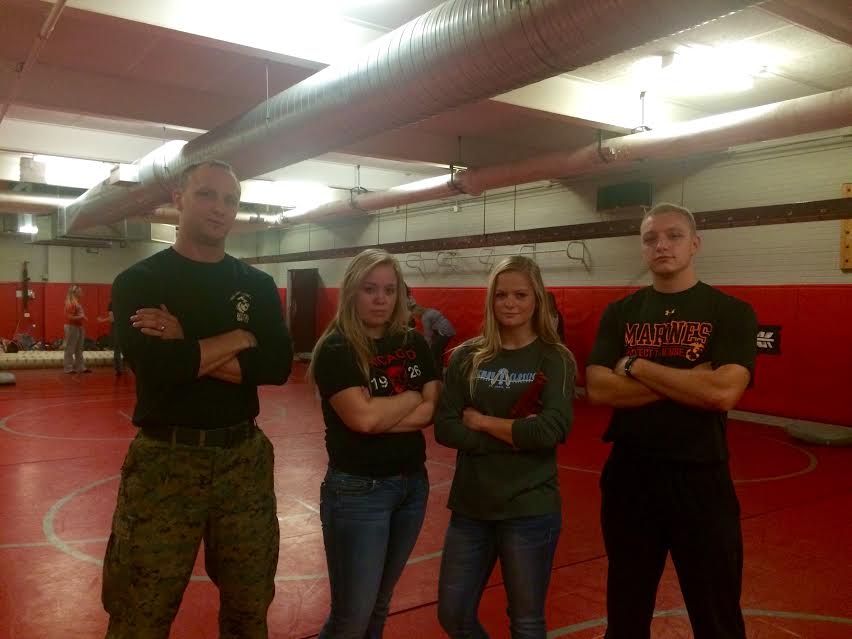 Marine Jason Moxley, senior Natalie Ivins, junior Natalie Nielsen and Marine Tommy Langbein posing after self defense training.