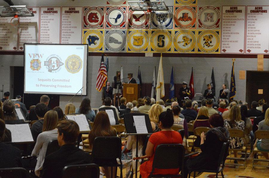 Voice of Democracy essay competition second place winner Kaleigh Miller shakes hands with a representative from VFW Post #4551.