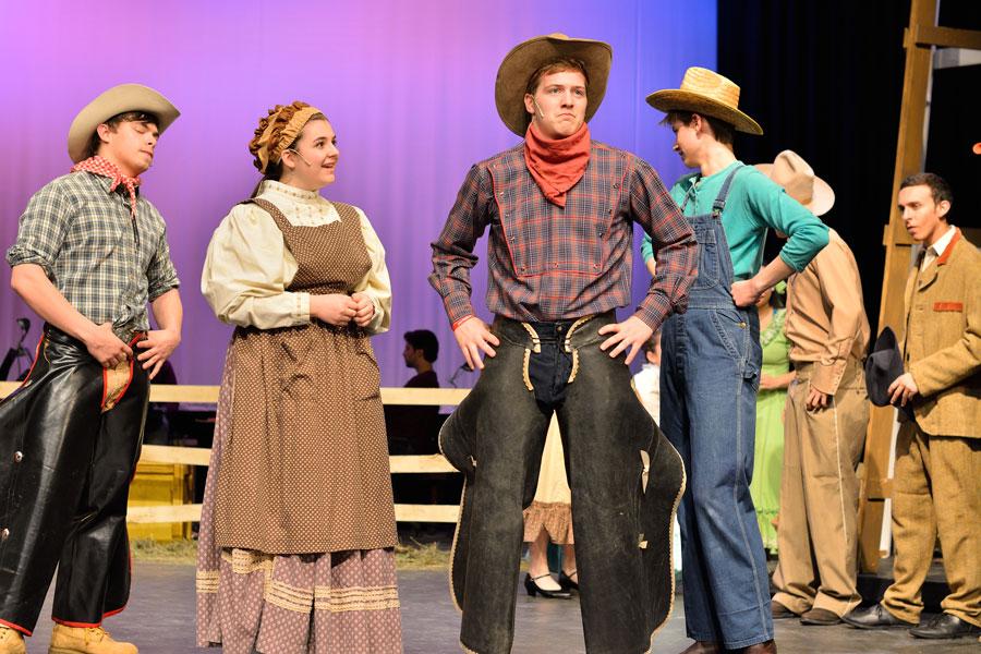 Senior Alex Fink, alumna Avery Herbon, alumnus Zac Keller and senior Riley Beckett take the stage for ACHS 2014 production of Oklahoma! The musical is on of many successful productions by ACHS students.