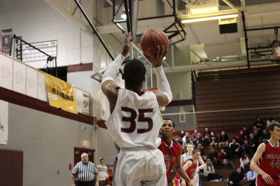 Junior Griffin Hill shoots a three pointer against Grant defender.