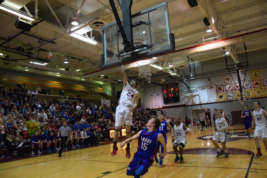 Junior Kyle Gofron going for a lay up against lakes defender.