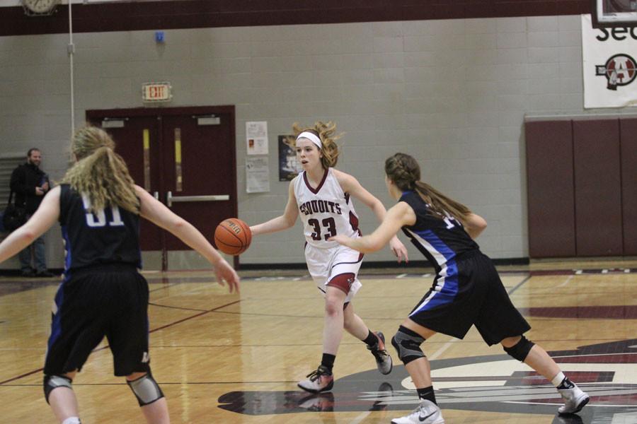 Junior Kelly Johnson drives down the court.