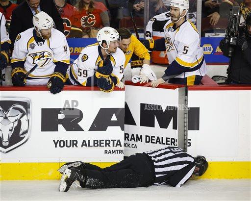 Linesman Don Henderson lying on the ice after being checked by Dennis Wideman.
(Associated Press).