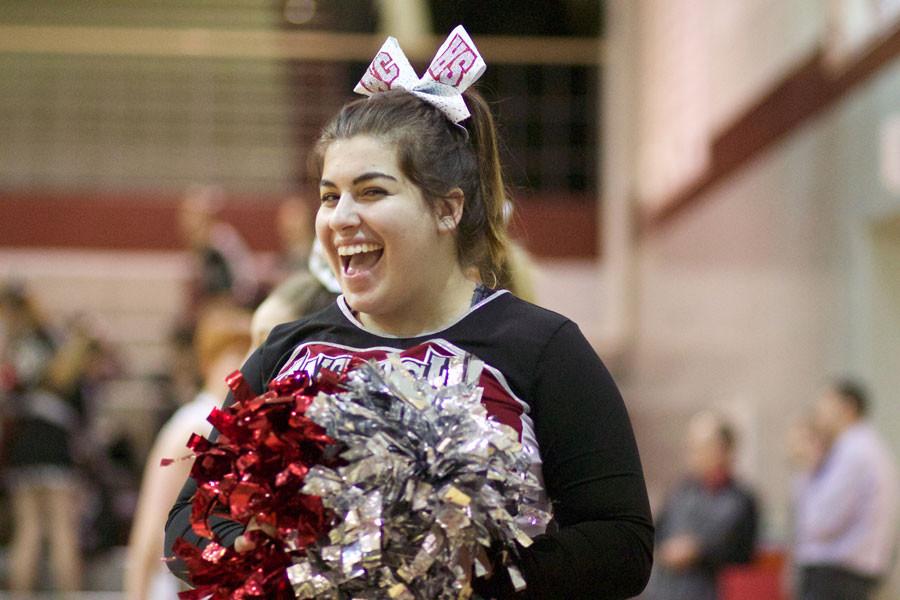 Sr. Cheerleader Andi Leineberg cheers for the Sequoits as they prepare to take on North Chicago  