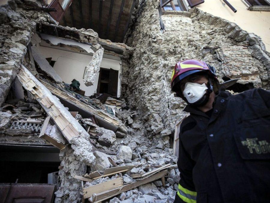 A firefighter walks past a collapsed house in Italy after Wednesdays earthquake.