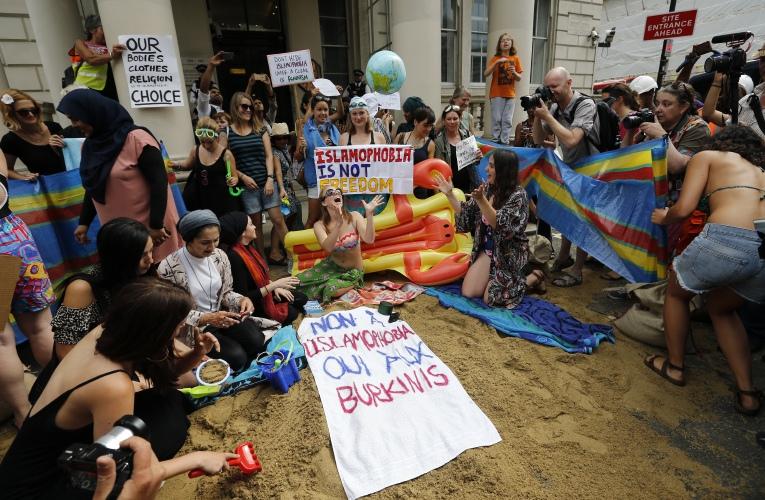 Activists protest outside the French embassy, during the wear what you want beach party in London. (AP Photo/Frank Augstein)