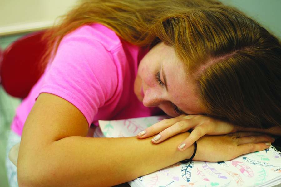 Senior Emma Miller takes a break before resuming her studies because she didn’t get enough sleep the night before. She went to sleep late the night before because she had homework from multiple AP classes and varsity cheer practice. Math teacher Andrew Benton said, “In order for your brain and body to work properly, you need adequate rest.”