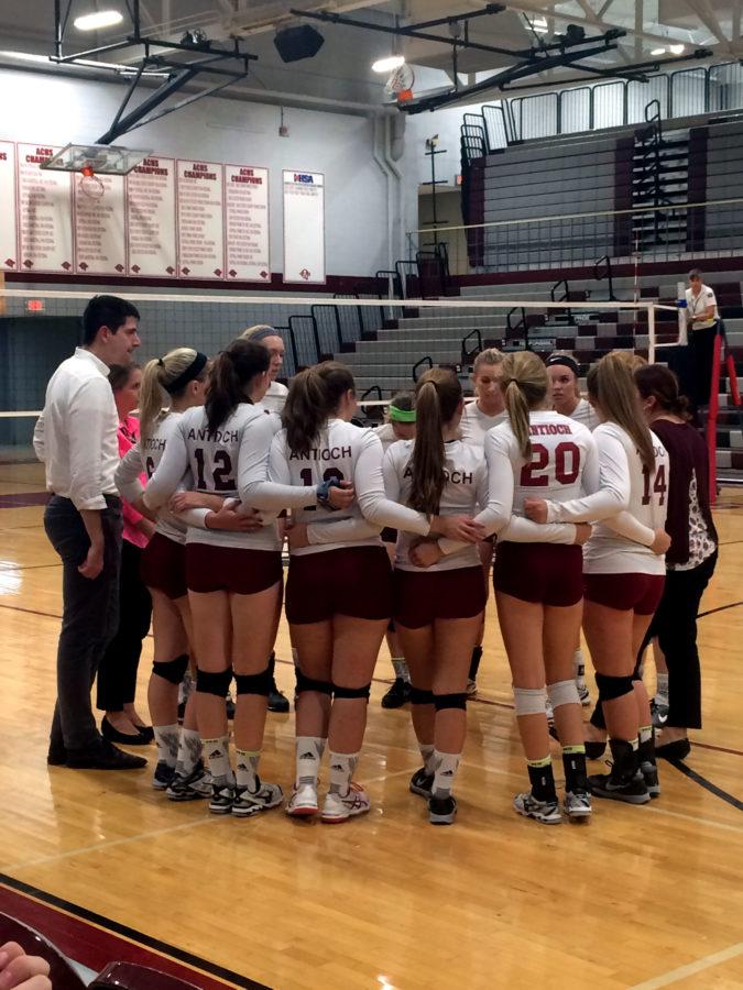 The+girls+Varsity+volleyball+gathers+in+a+huddle+to+discuss+their+goals+for+the+game.