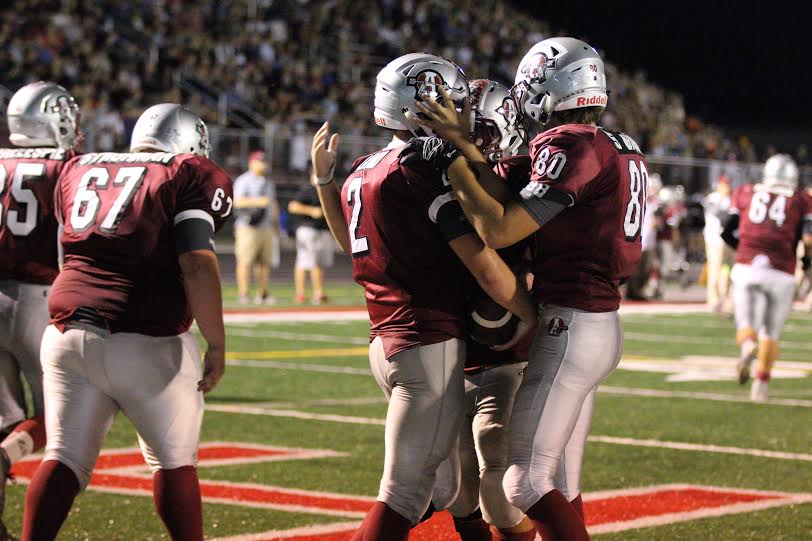 Senior+Brandon+Lind+and+junior+Steven+Baum+celebrate+after+a+touchdown.