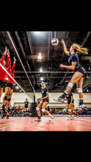 Junior Amanda Rowe jumps up for a spike against an opponent to get her team a point. 