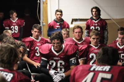 The boys football team gathers after after a win against Wauconda on October 28.