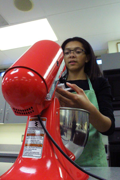 While mixing, stirring and blending after school on Tuesday, Dec. 6, freshman Tiana Fox made cookie dough for FCCLAs holiday fundraiser. The organization sold cookies to staff and students in order to raise money for the groups upcoming state competitions. Caption by Arturo Mendez 