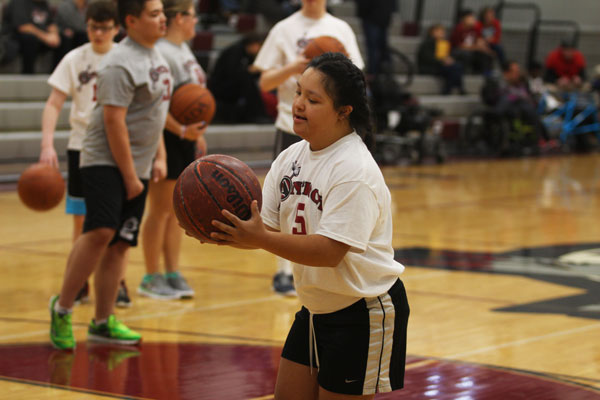 Sophomore Karyme Ramirez warms up for the annual Sidekicks basketball game Dec. 10. Ramirez showed off her skills on the court. Caption by Steffanie Richardson