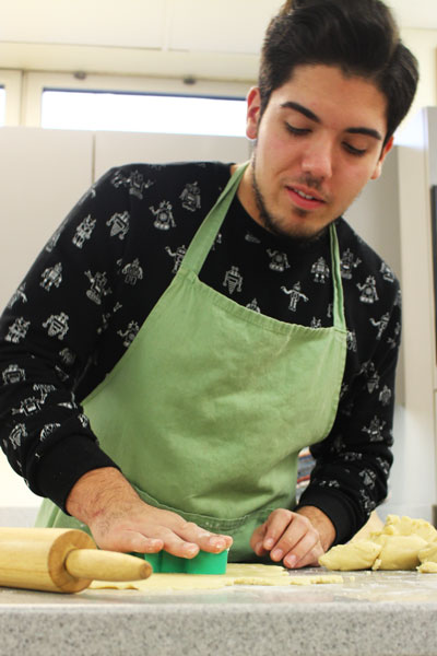 During Mrs. Tielkes 8th hour Foods 1 class the students split up to make sugar cookies. After rolling out the dough, junior Robert Londono, used festive cookie cutters to shape the cookies. Caption by Gabby Mowry