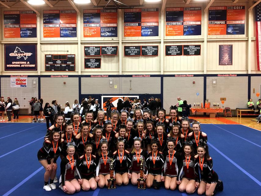 The JV and Varsity cheer teams pose after they both win 1st place in their most recent competition.