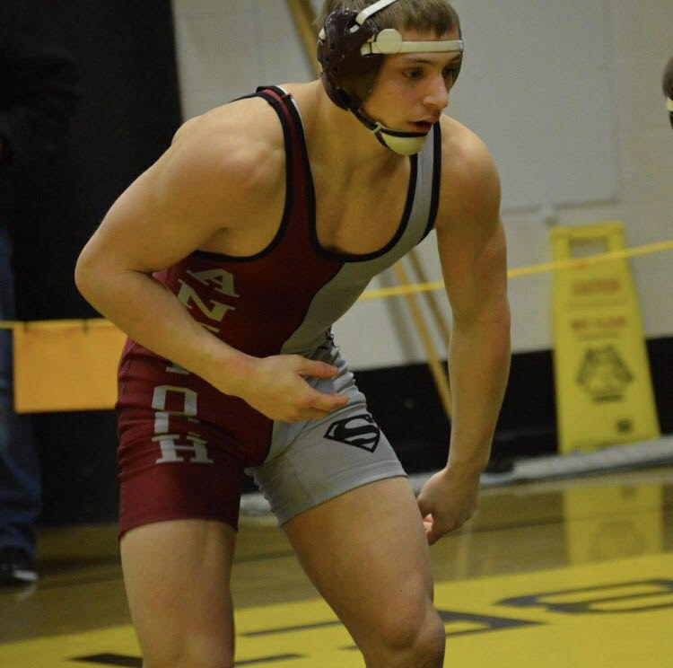 Senior Patrick Schoenfelder prepares for his match against Round Lake on January 9. Schoenfelder went on to win the match, adding to the overall team win.
