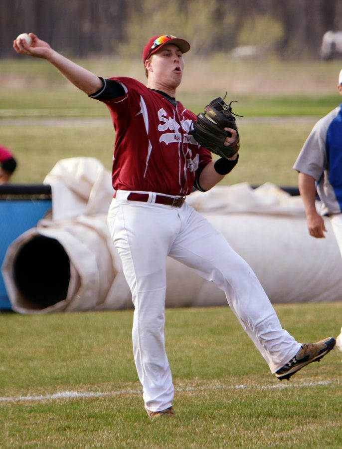 After a hit, Benjamin Gutke throws a ball to first looking to get an out.