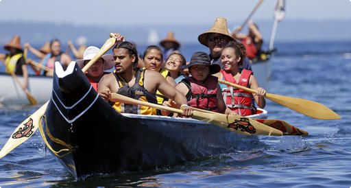 A canoe from the Puyallup Tribe is paddled toward a landing during an annual journey Wednesday, July 27, 2016, in Seattle. Dozens of tribal canoes were arriving at Alki Beach in Seattle as part of an annual Native American celebration. Members of the Muckleshoot Tribe greeted the boats Wednesday afternoon as part of the 2016 Paddle to Nisqually. 