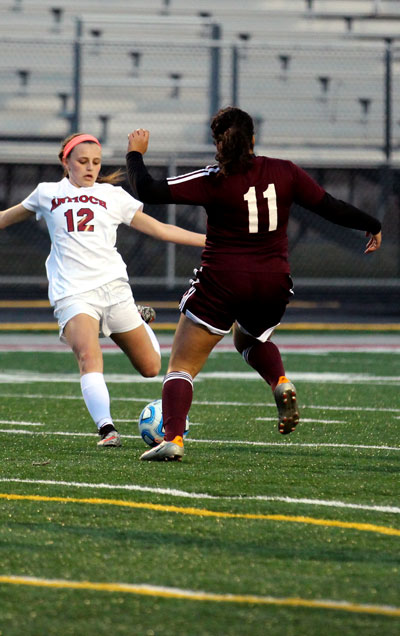 Junior Ella Roberts kicking the ball in their game against Zion-Benton.