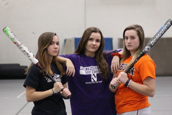 Three members of the Varsity softball team sport t-shirts of some of their favorite college softball teams. Watching college softball is a great way to stay in the game when not playing and learn new skills. “I like watching college softball because of all the cool plays that they do and it makes me even more excited for college,” senior Jillian Foote said.