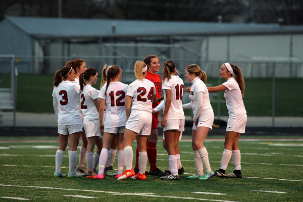 Junior and Captain Monica Wilhelm breaks out the team at the beginning of their game on April 11.