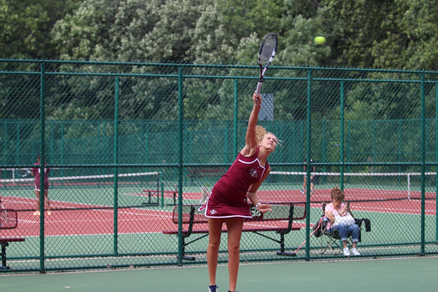 Kelsey Neville serves during her match against Zion-Benton on Wednesday, August 30. 