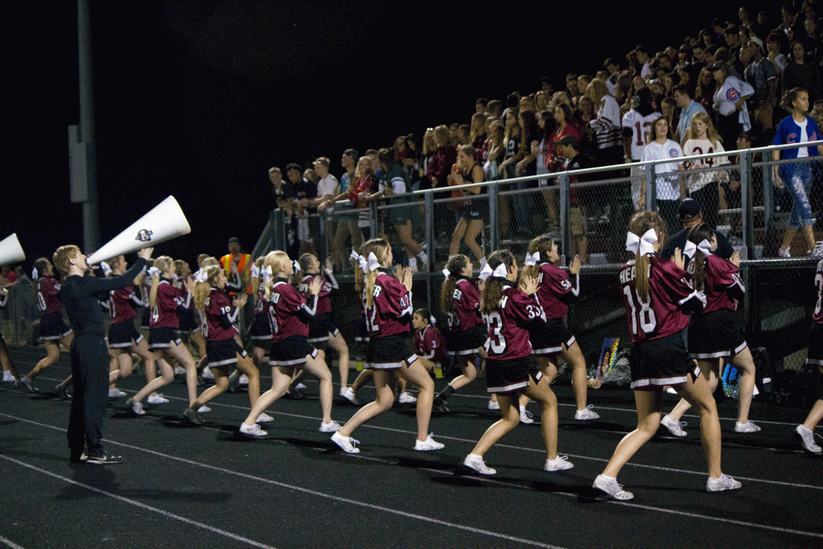 The+varsity+cheerleaders+encourage+the+Cardinal+Crazies+to+cheer+on+the+Sequoits+at+Grant+Community+High+School.+