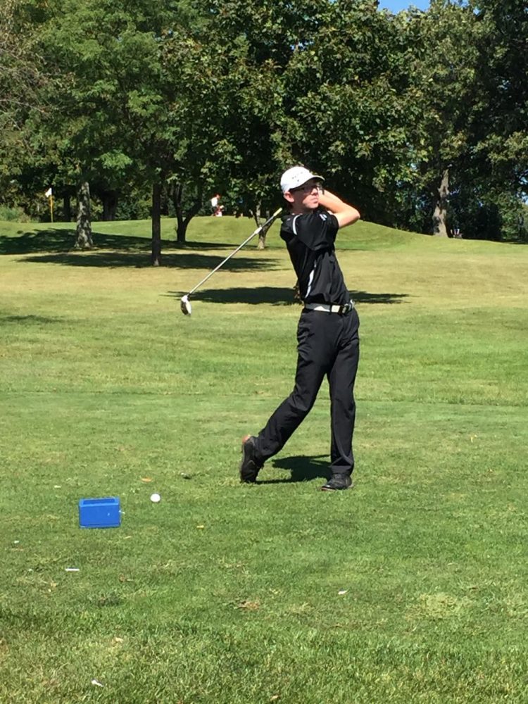 Junior Nick Gagman prepares to tee off with his three wood.