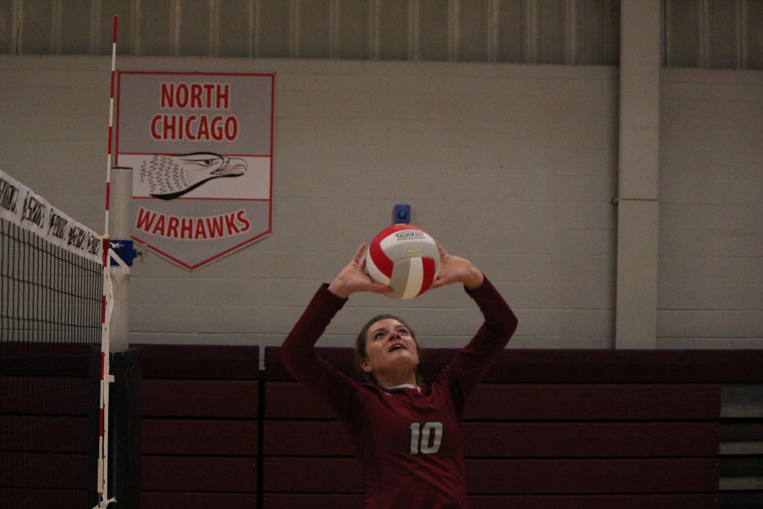 Junior Grace Weber sets the ball over the net.