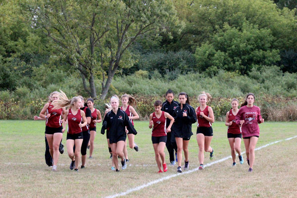 Girls cross country getting their stretches in before their race.