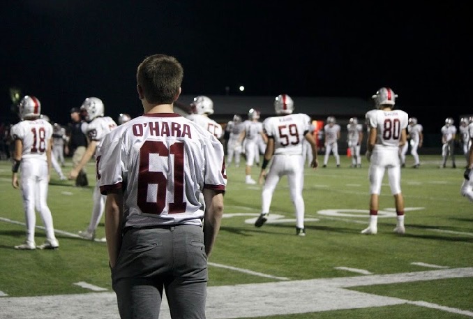 Sophomore Sean OHara watches his teammates stretch before the second half of their football game versus Grant.The Sequoits beat the Bulldogs 42-0, bringing their record to 4-0. This is probably the hardest thing I have had to do, having to deal with an injury, OHara said.