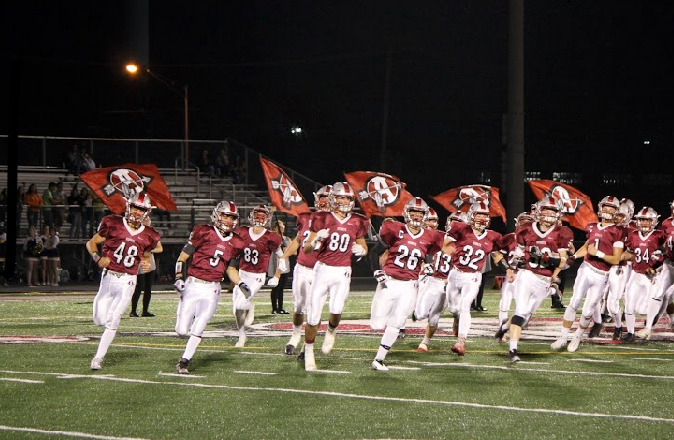 The Antioch Sequoits football team runs out onto the field.