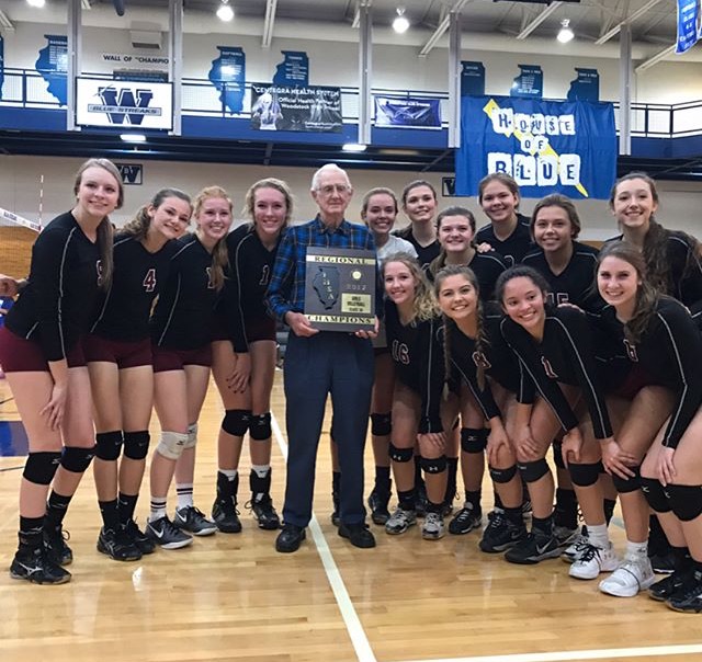 Girls volleyball team pictured with their regional championship trophy.