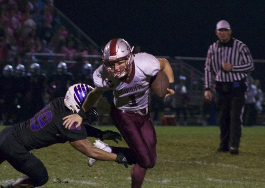 Quarterback Branden Gallimore fights back against the Eagles defense.