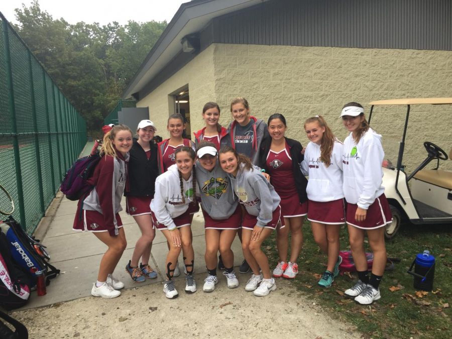 The+girls+varsity+tennis+team+is+excited+to+continue+their+matches+on+Saturday+despite+the+oncoming+rain.