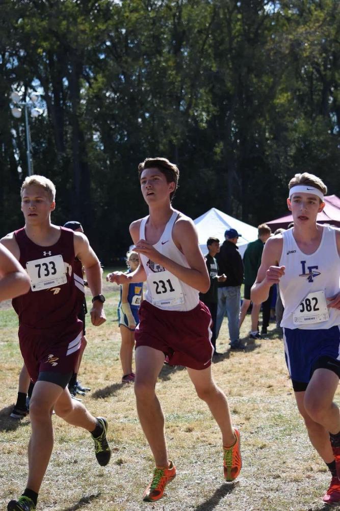 Senior Alex Besson keeps his pace with other runners at the meet.