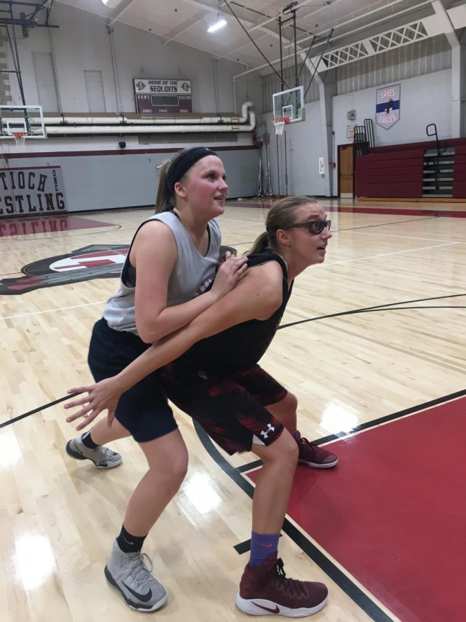 Junior Samantha Brown (right) boxes junior Kaitlynn Stay (left) to keep her from getting the rebound.