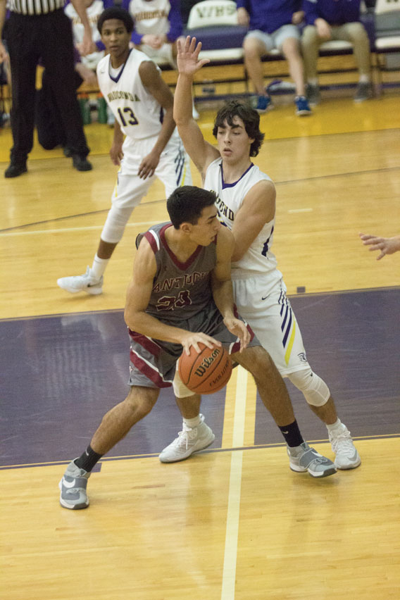 Junior Jack Gillespie drives the ball to the hoop in a close game against the Wauconda Bulldogs.