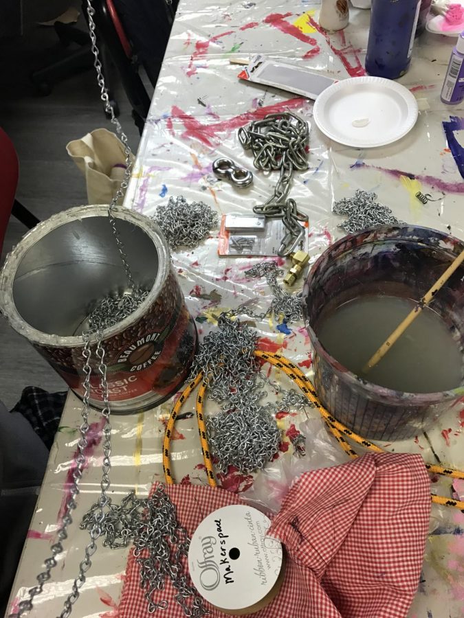 Materials are strewn across a table as a Sequoit works on a project