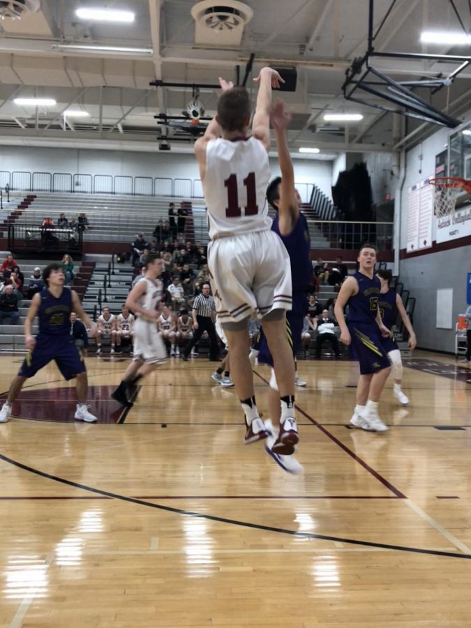 Andrew Hare shooting a three-pointer against the Wauconda Bulldogs.