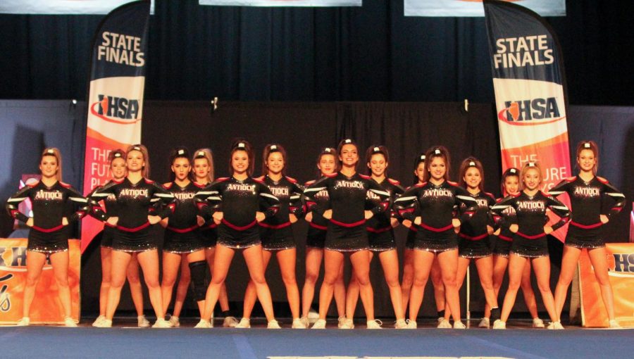 The varsity cheerleading squad stands tall, prepared for their upcoming performance on the first day of the state finals. The team advanced to day two.