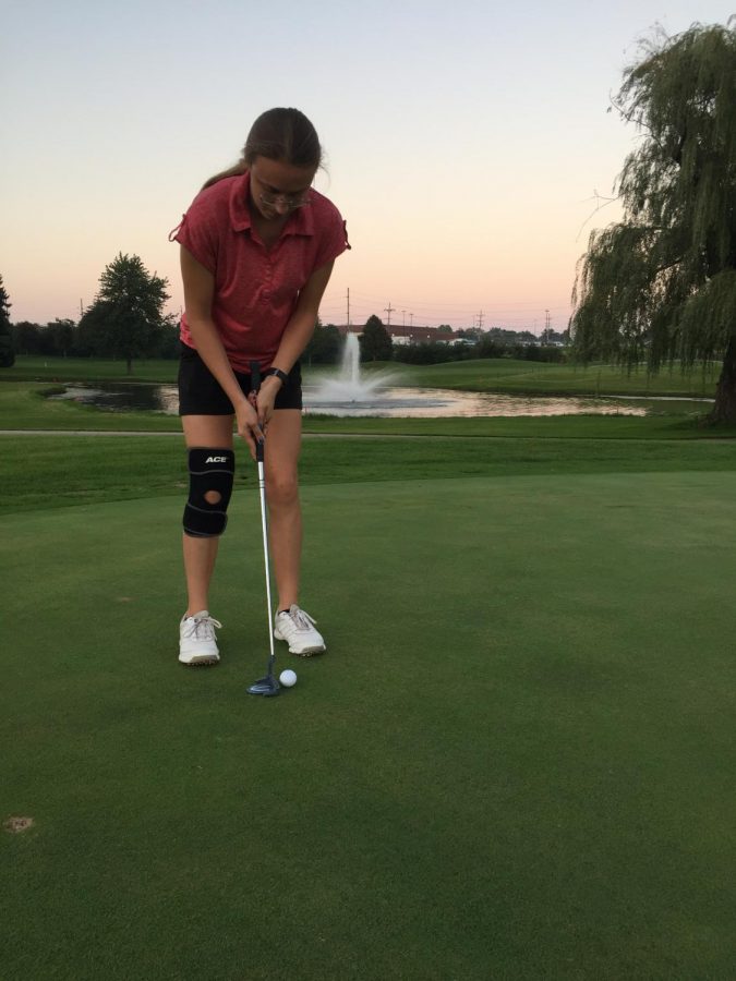 Samantha brown prepares to hit her putt.
