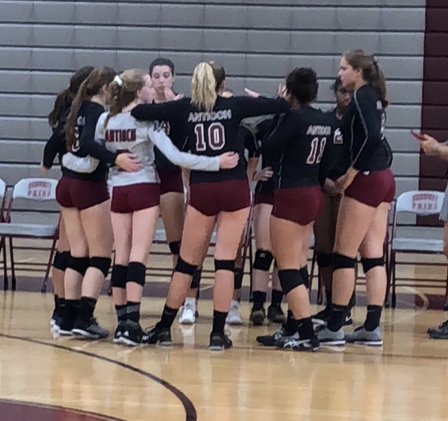 The girls varsity volleyball team gets ready for their game against the Warhawks.