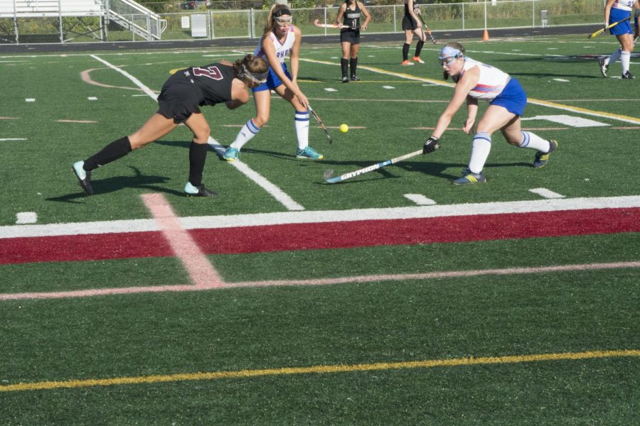 The Antioch field hockey team pushes forward to try and win the ball.