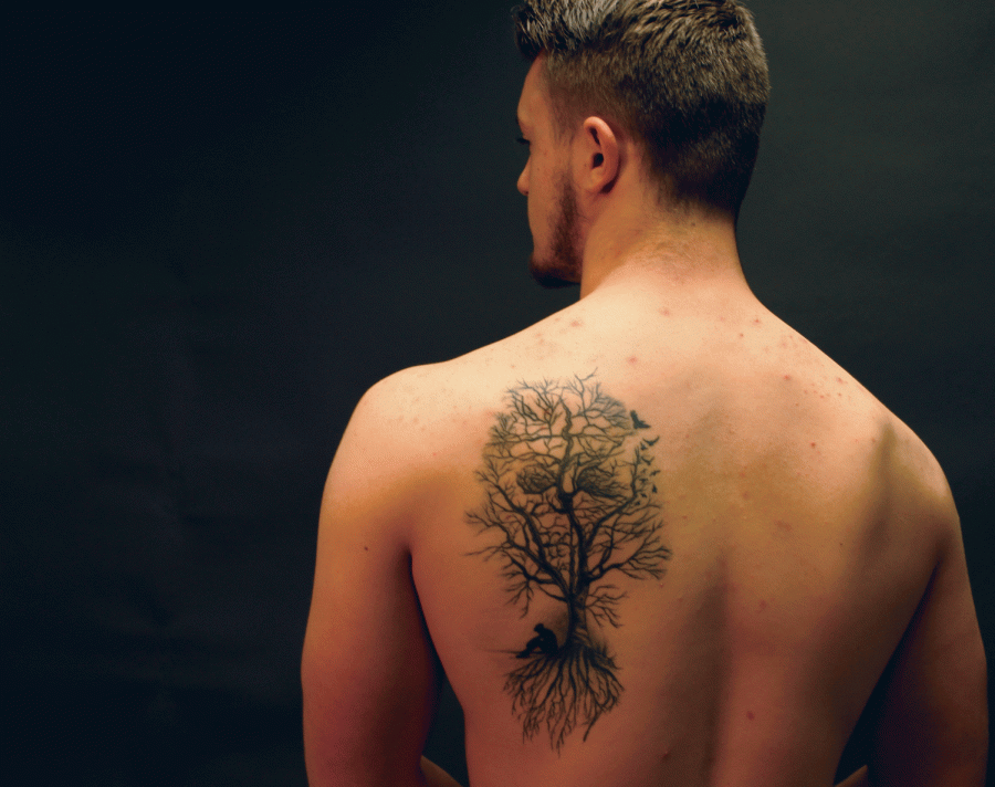 Senior Chase Becker poses to display the tattoo he got in memory of his mother.