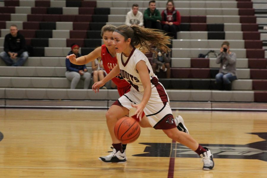 Senior Piper Foote steals the basketball from Grant.